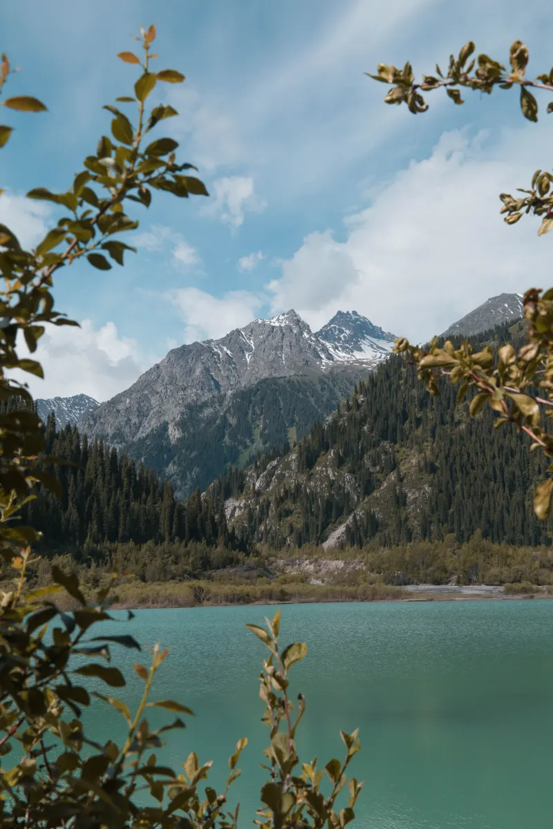 Big Almaty Lake surrounded by snow-capped mountains